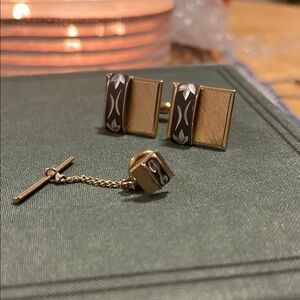 Vintage gold cufflink with a black enamel inlay and matching tie pin.